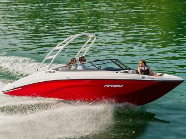 Slide: The Image of 2024 Yamaha Boats AR190 speeding on a lake with passengers. - 21
