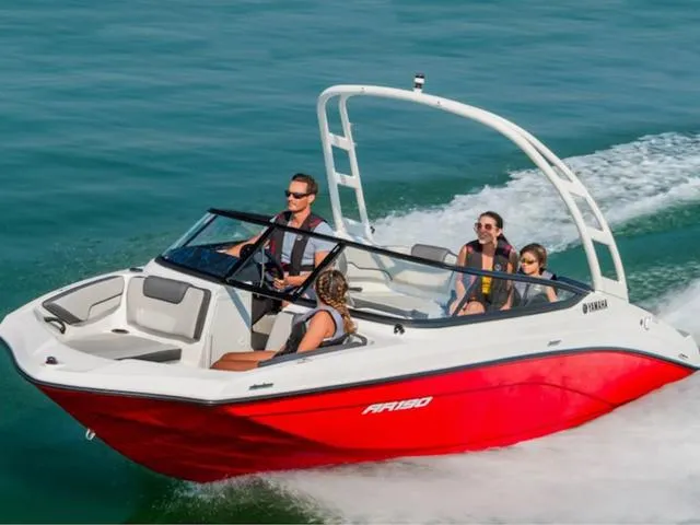 Slide: The Image of 2024 Yamaha Boats AR190 speeding on water with passengers. - 22