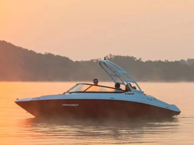 Slide: The Image of 2024 Yamaha Boats AR190 on calm water at sunset. - 23