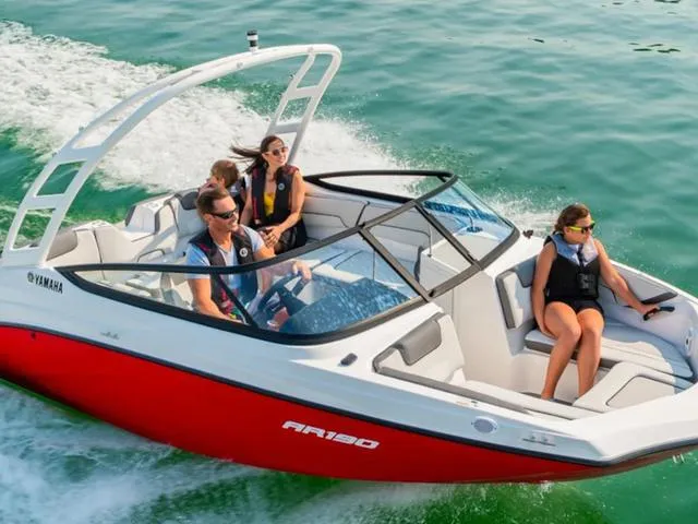 Slide: The Image of 2024 Yamaha Boats AR190 cruising on water with passengers. - 25