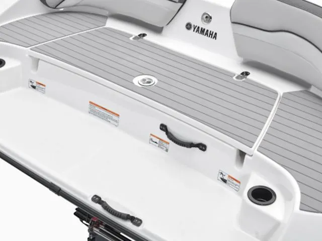 Slide: The Image of 2024 Yamaha Boats AR190 swim platform with gray decking and cup holders. - 27