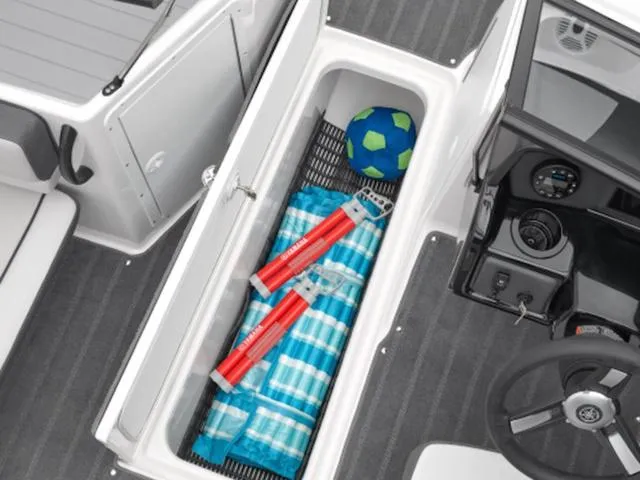 Slide: The Image of 2024 Yamaha Boats AR190 storage compartment with beach gear and safety equipment. - 29