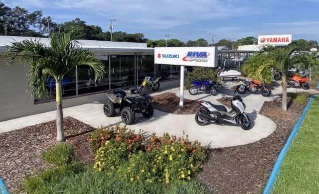 Slide: The Image of Outdoor display of Yamaha and Suzuki motorcycles and ATVs at a dealership. - 31