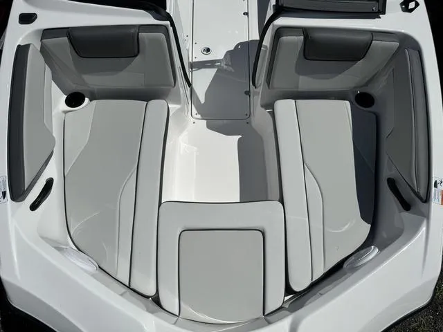 Slide: The Image of 2024 Yamaha Boats AR190 interior seating area with gray cushions. - 9