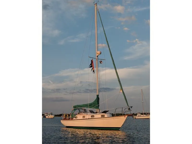 The Image of 1982 Cape Dory 30 sailboat on calm water at sunset. - 0