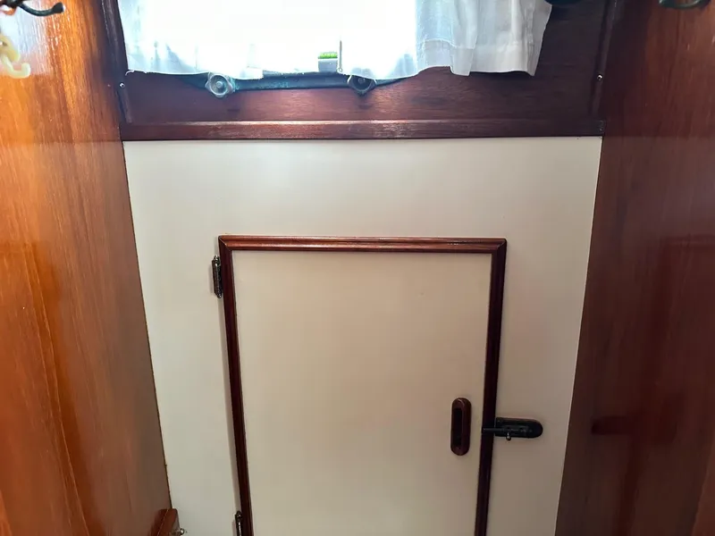 Slide: The Image of Interior of 1982 Cape Dory 30 sailboat with wooden door and window. - 21