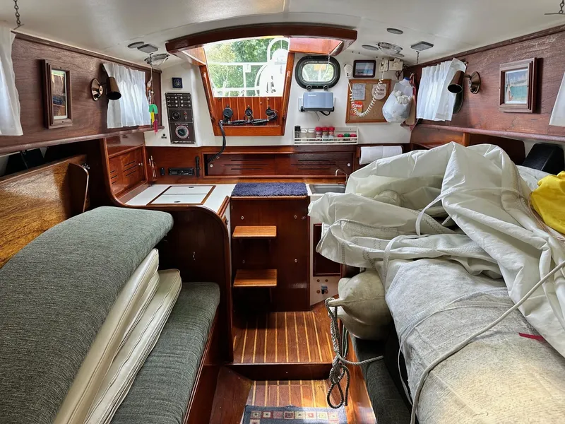 Slide: The Image of Interior of 1982 Cape Dory 30 sailboat with wooden finishes and nautical equipment. - 22