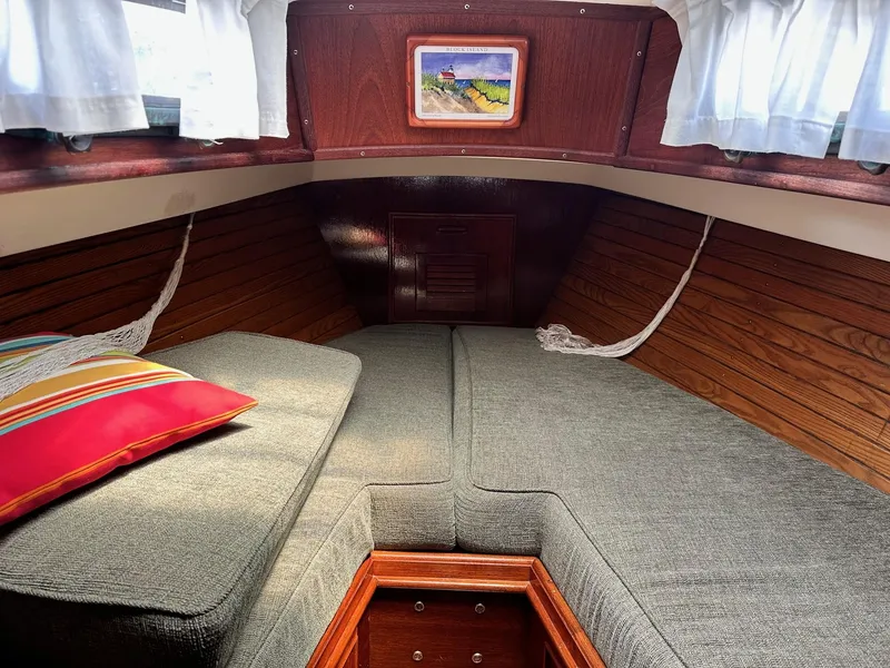 Slide: The Image of Cozy cabin interior of 1982 Cape Dory 30 sailboat with cushions and colorful pillow. - 28