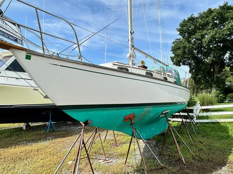 Slide: The Image of 1982 Cape Dory 30 sailboat on stands, white hull, green bottom, outdoors. - 3