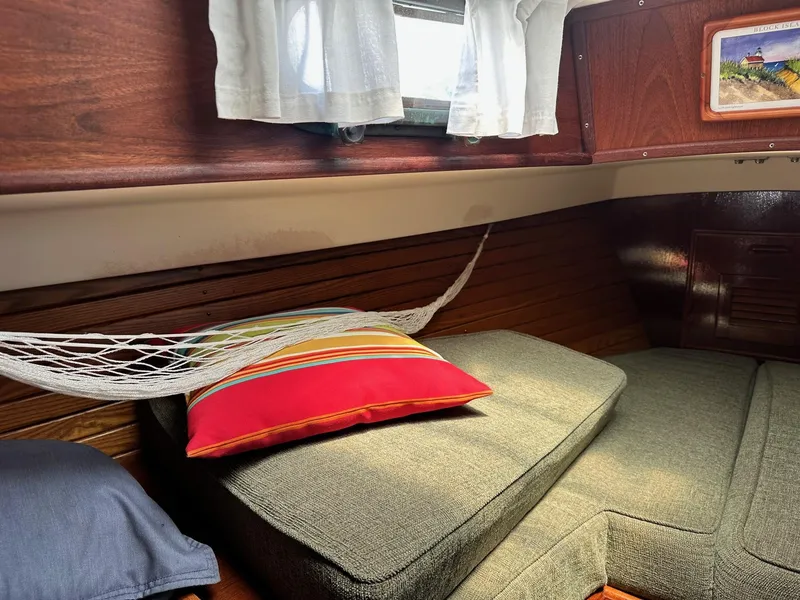 Slide: The Image of Cozy interior of 1982 Cape Dory 30 sailboat with cushions and colorful pillow. - 30