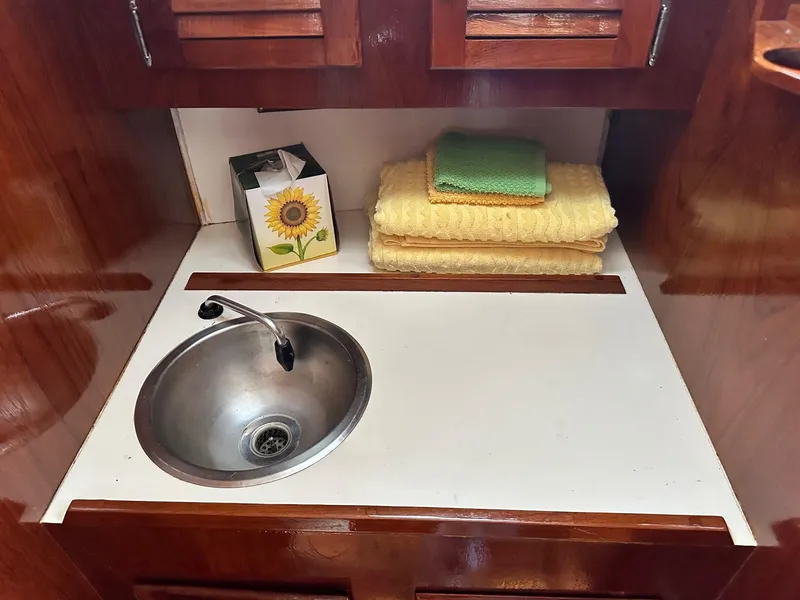 Slide: The Image of 1982 Cape Dory 30 yacht interior with sink, towels, and sunflower tissue box. - 31