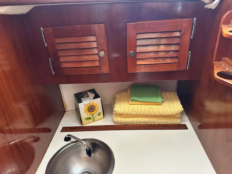 Slide: The Image of Interior of 1982 Cape Dory 30 sailboat with wooden cabinets and sink. - 32