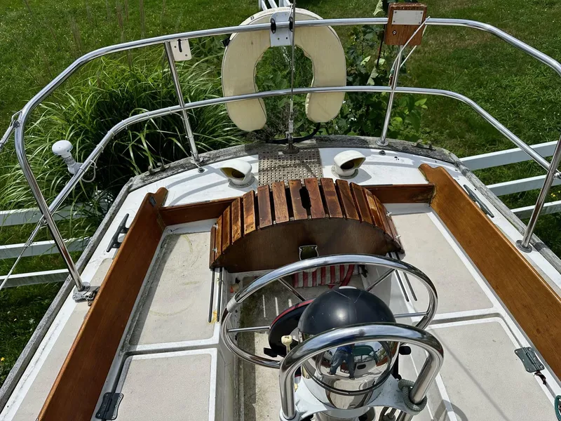 Slide: The Image of 1982 Cape Dory 30 sailboat cockpit with wooden accents and steering wheel. - 9