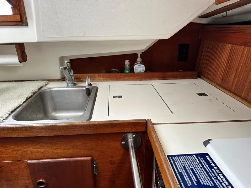 Slide: The Image of 1986 Sabre 30 Sabre MK III yacht galley with sink and storage compartments. - 15