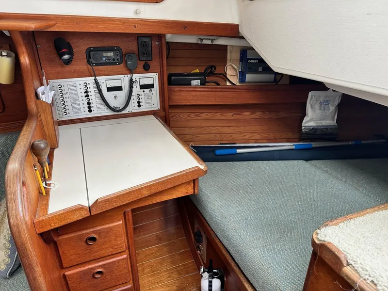 Slide: The Image of Navigation station of a 1986 Sabre 30 Sabre MK III sailboat with control panels and seating. - 16