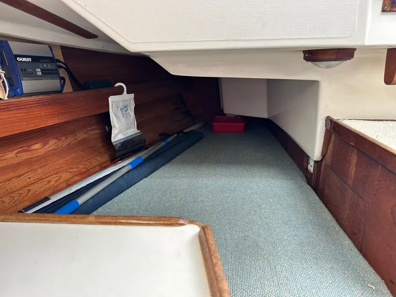 Slide: The Image of Interior storage area of a 1986 Sabre 30 Sabre MK III sailboat with equipment and wooden paneling. - 18