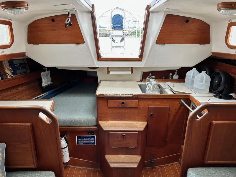 Slide: The Image of 1986 Sabre 30 Sabre MK III sailboat interior with wood cabinetry and compact kitchen area. - 19