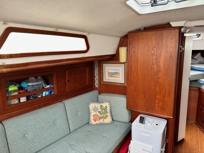 Slide: The Image of Interior of 1986 Sabre 30 Sabre MK III sailboat with wooden cabinetry and cushioned seating. - 21