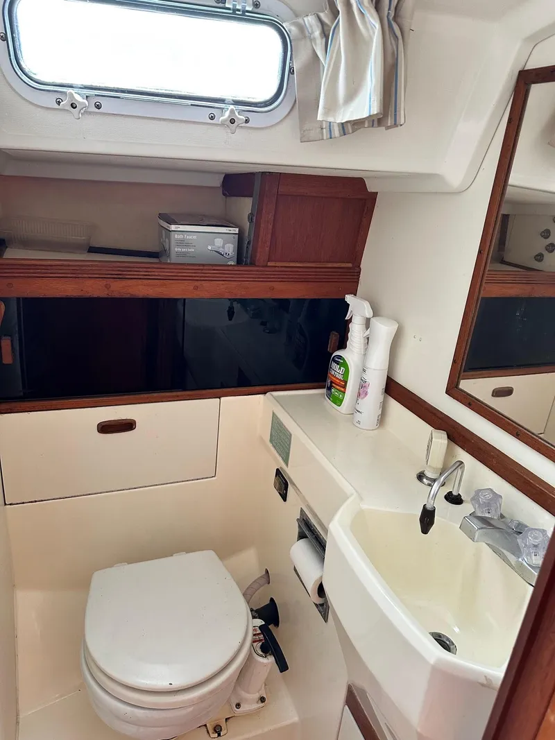 Slide: The Image of Compact bathroom in 1986 Sabre 30 Sabre MK III sailboat with toilet, sink, and storage. - 25