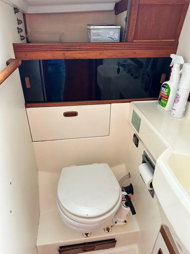 Slide: The Image of 1986 Sabre 30 Sabre MK III boat bathroom with toilet, sink, and storage cabinets. - 27