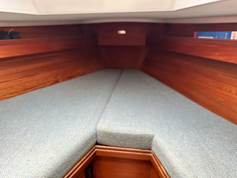 Slide: The Image of Interior cabin of 1986 Sabre 30 Sabre MK III sailboat with wooden paneling and cushioned seating. - 30