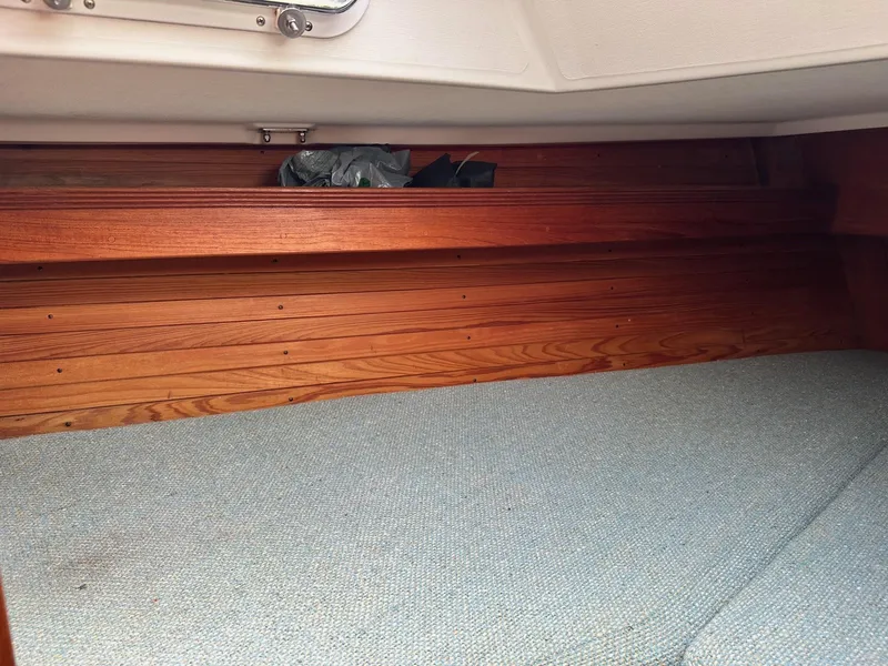 Slide: The Image of Interior cabin of 1986 Sabre 30 Sabre MK III sailboat with wooden paneling and blue upholstery. - 31