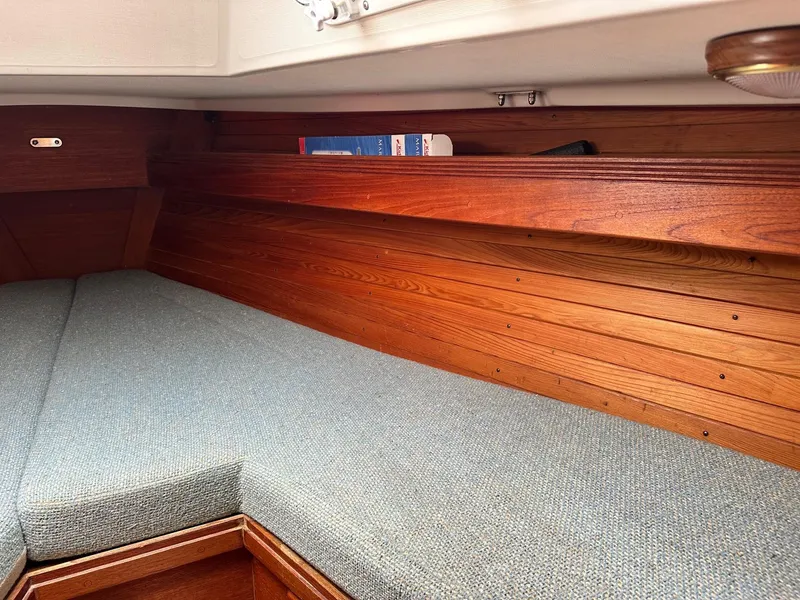 Slide: The Image of Interior cabin of 1986 Sabre 30 Sabre MK III sailboat with wooden paneling and cushioned seating. - 32