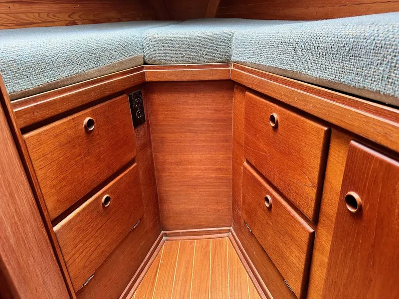 Slide: The Image of Interior cabin storage of 1986 Sabre 30 Sabre MK III sailboat with wooden drawers and cushioned seating. - 34