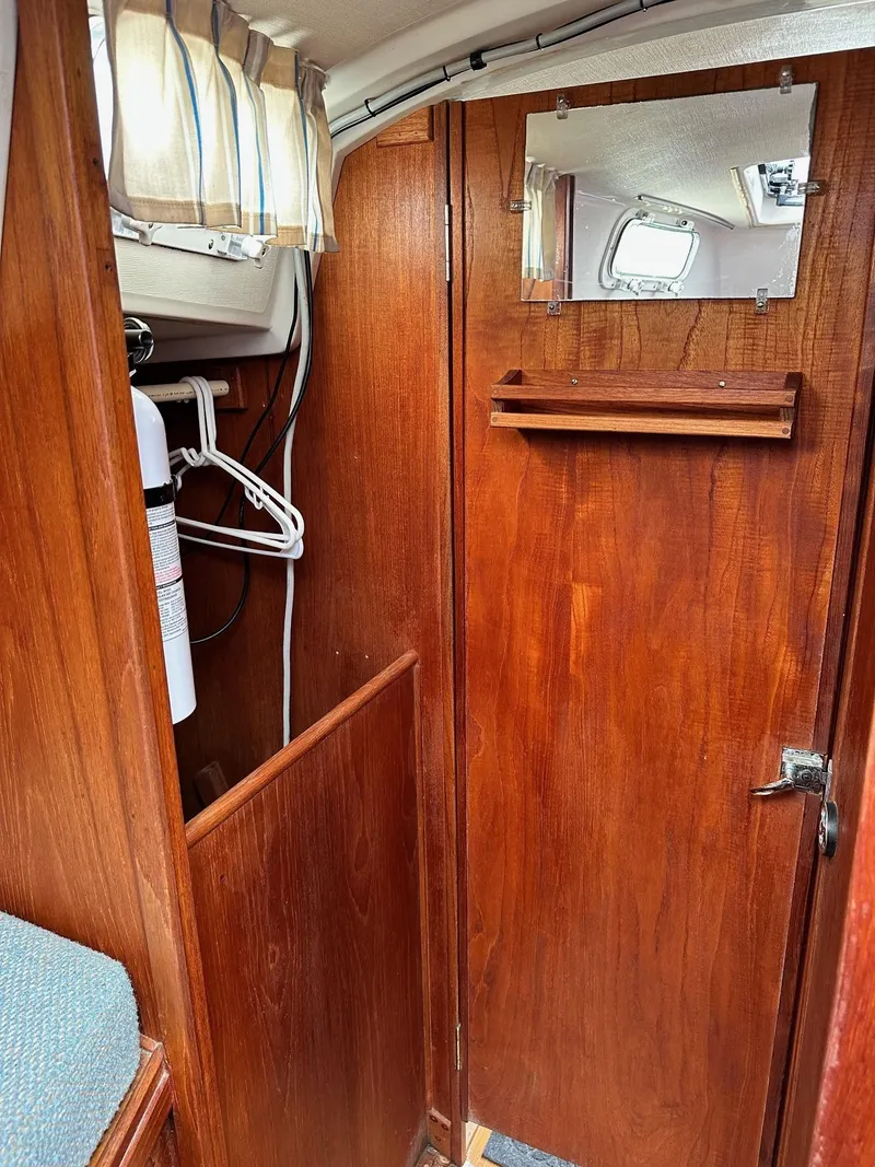 Slide: The Image of Interior of 1986 Sabre 30 Sabre MK III sailboat with wooden cabinetry and mirror. - 35