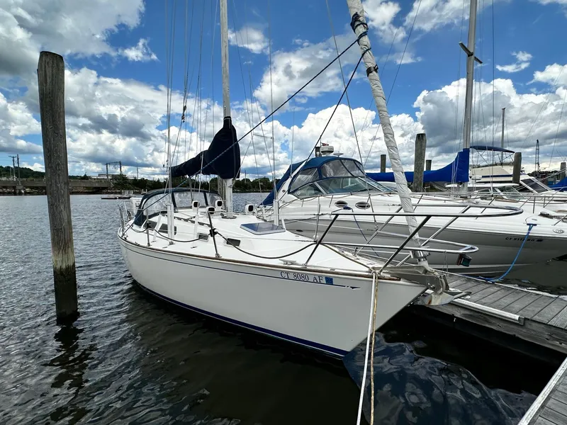 Slide: The Image of 1986 Sabre 30 Sabre MK III sailboat docked at a marina under a partly cloudy sky. - 4