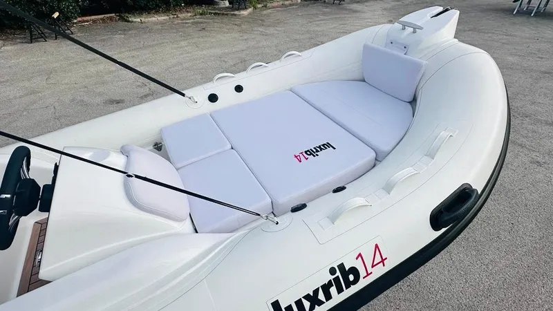 Slide: The Image of Aqvaboats LUXRIB 14, 2024 model, luxury inflatable boat with cushioned seating. - 10