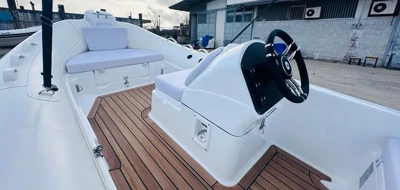 Slide: The Image of 2024 Aqvaboats LUXRIB 14 with teak deck and white seating. - 13