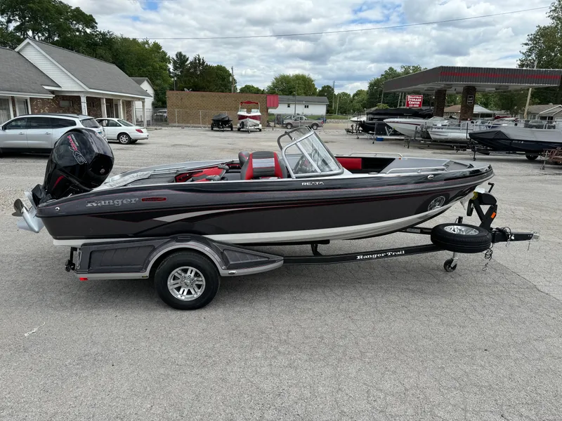 Slide: The Image of 2024 Ranger 1850MS boat on trailer, parked outdoors, with a sleek black and red design. - 4