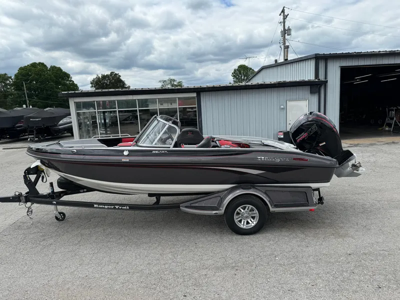 Slide: The Image of 2024 Ranger 1850MS boat on trailer, parked outside a building under cloudy skies. - 7