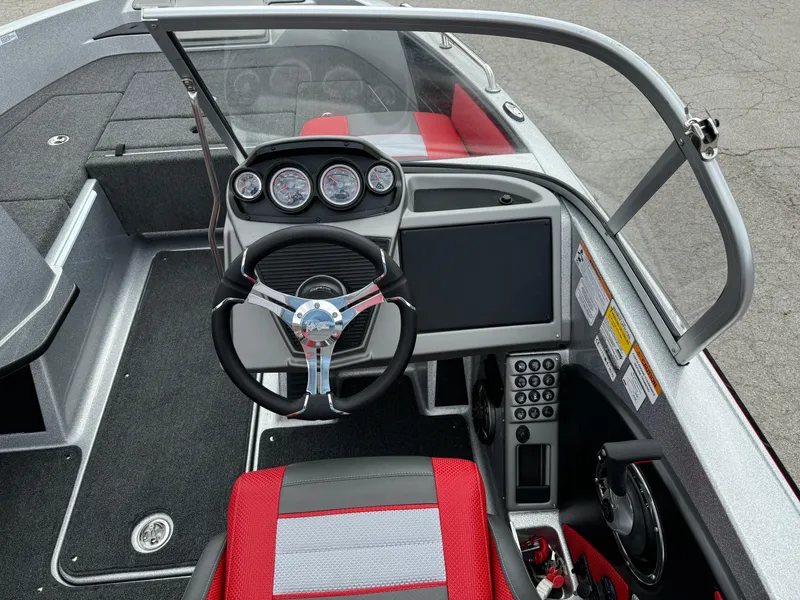 Slide: The Image of 2024 Ranger 1850MS boat interior with steering wheel, dashboard, and red seating. - 9