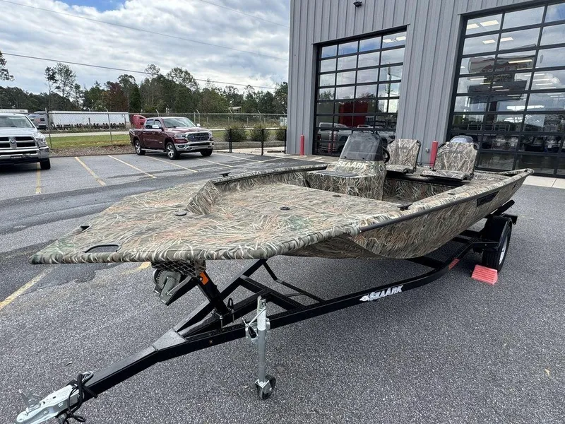 The Image of 2025 SeaArk Shadow 17 Side Console boat with camouflage design on a trailer. - 1