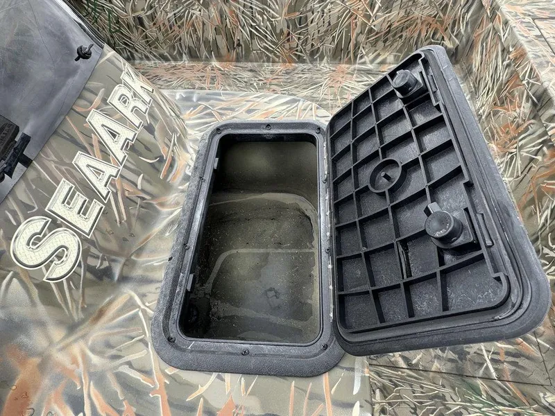 Slide: The Image of 2025 SeaArk Shadow 17 Side Console boat with camouflage design in parking lot. - 13