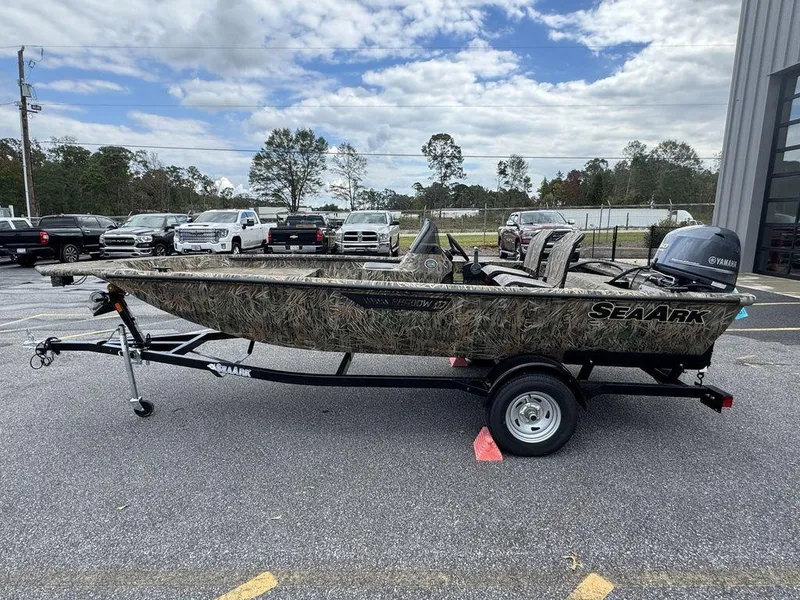 Slide: The Image of 2025 SeaArk Shadow 17 Side Console boat on trailer, parked outdoors. - 11