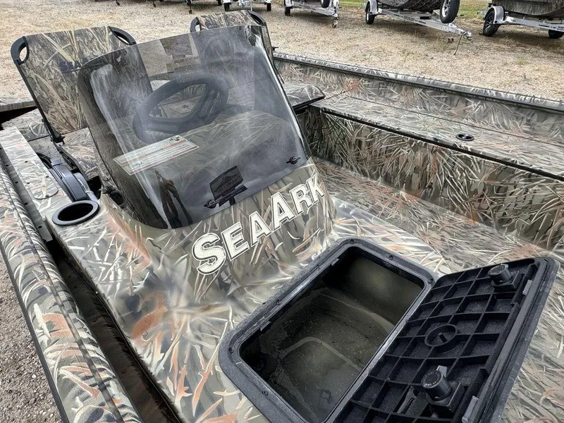 Slide: The Image of 2025 SeaArk Shadow 17 Side Console boat with camouflage design and open storage compartment. - 14