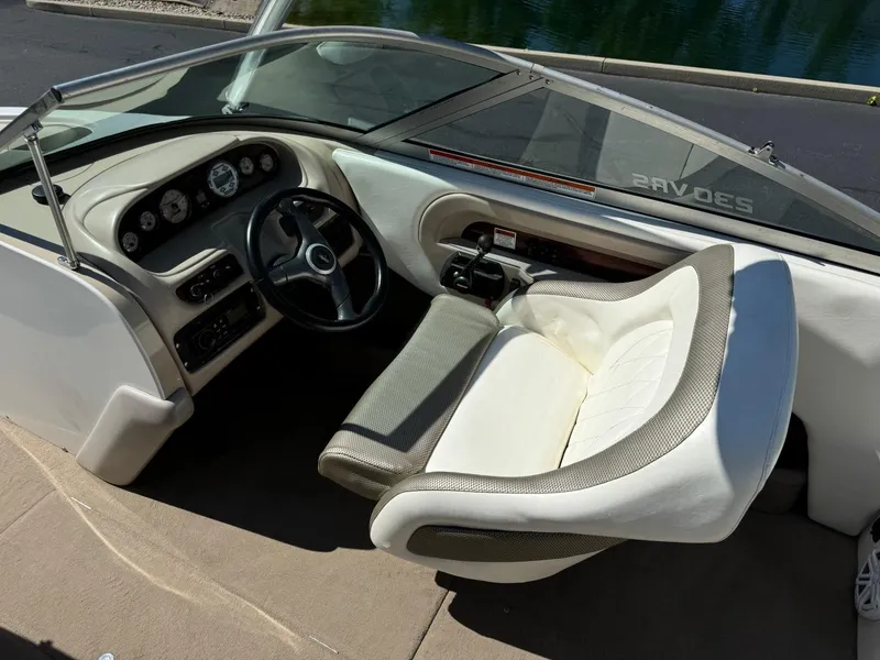 Slide: The Image of 2000 MasterCraft MariStar 230 VRS boat cockpit with steering wheel and captain's chair. - 11