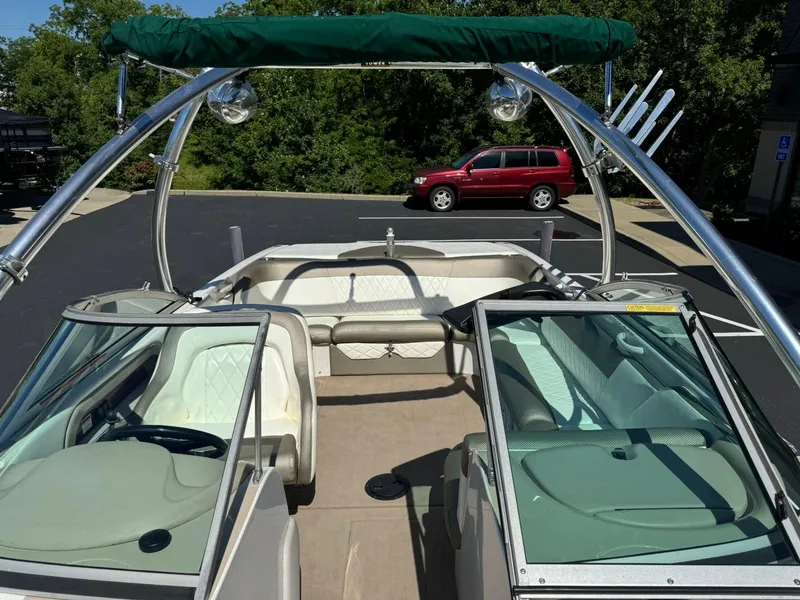 Slide: The Image of 2000 MasterCraft MariStar 230 VRS boat interior with green bimini top and white seating. - 13