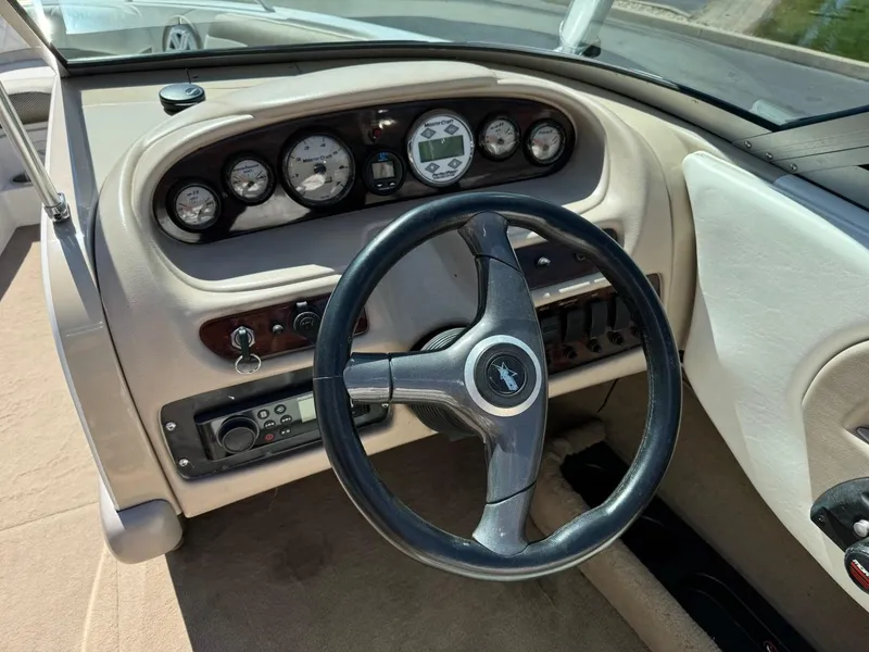 Slide: The Image of 2000 MasterCraft MariStar 230 VRS boat dashboard with steering wheel and gauges. - 16