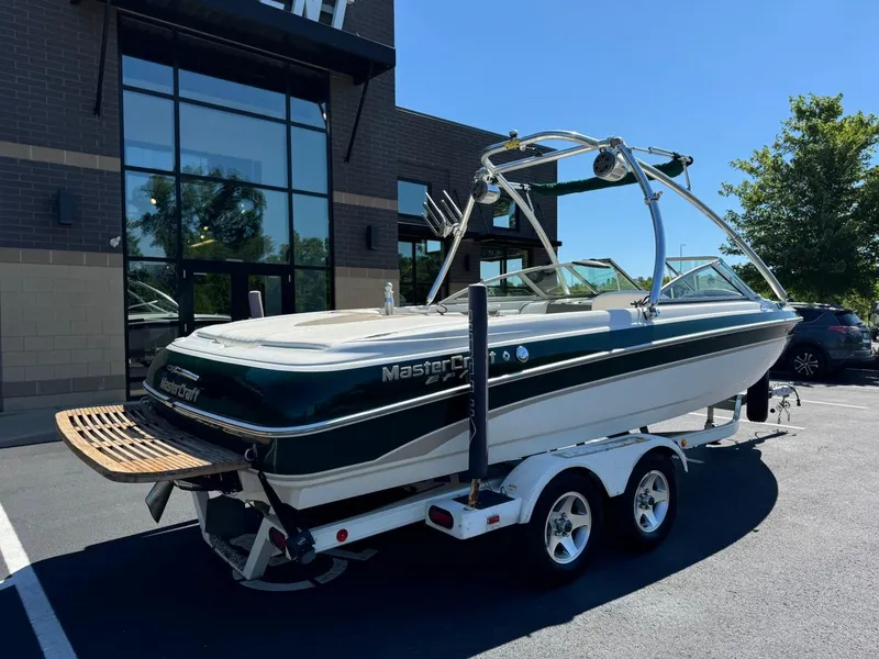 Slide: The Image of 2000 MasterCraft MariStar 230 VRS boat on a trailer outside a building. - 3