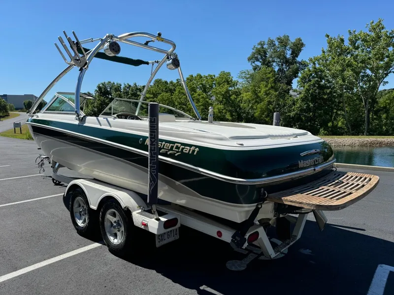 Slide: The Image of 2000 MasterCraft MariStar 230 VRS boat on a trailer in a parking lot. - 5