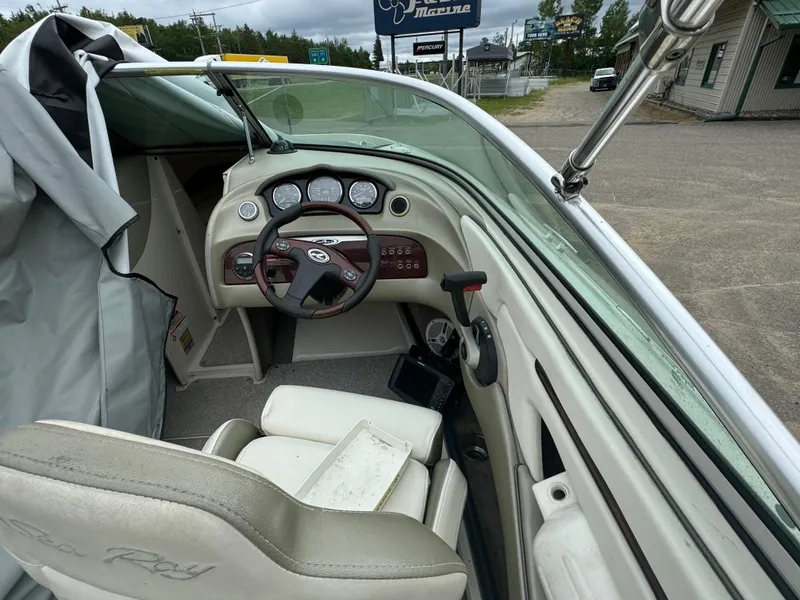 Slide: The Image of 2007 Sea Ray 220 Select boat interior with steering wheel and dashboard. - 2