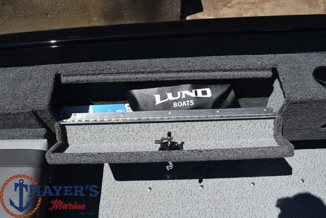 Slide: The Image of 2025 Lund 1775 Adventure SS boat storage compartment with Thayer's Marine logo. - 14