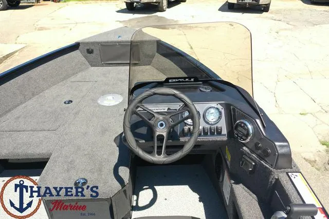 Slide: The Image of 2025 Lund 1775 Adventure SS boat interior with steering wheel and dashboard at Thayer's Marine. - 22
