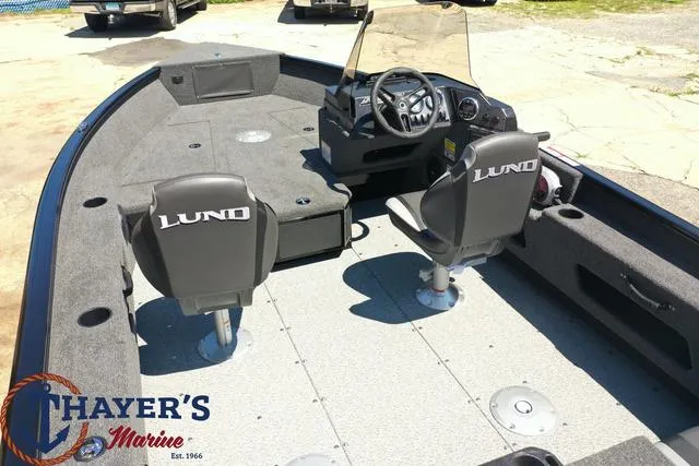 Slide: The Image of 2025 Lund 1775 Adventure SS fishing boat interior with two seats and steering console. - 23