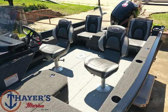 Slide: The Image of 2025 Lund 1775 Adventure SS fishing boat interior with seating, steering console, and Thayer's Marine logo. - 29