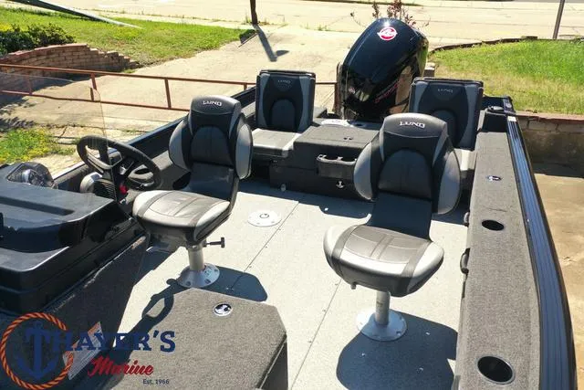 Slide: The Image of 2025 Lund 1775 Adventure SS boat interior with seating and motor. - 31